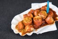 Typical German Currywurst street food is grilled and sliced sausage with curry ketchup in paper plate