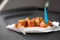 Typical German Currywurst street food is grilled and sliced sausage with curry ketchup in paper plate in car on the go
