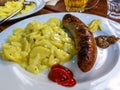 Typical German food with sausages, mustard, tomato ketchup and potato salad Royalty Free Stock Photo
