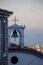 Typical Greek Church Bells and Cross and Sea at the Background at the Aegean Sea and the Sporades on the Greek Island of Alonissos Royalty Free Stock Photo