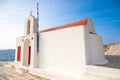 Typical Greek church white building with red dome against the blue sky on the island Mykonos, Greece Royalty Free Stock Photo