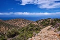 Typical Greek or Cretan landscape, hills and mountains, spring foliage, bush, olive tree, rocky road, path. Akrotiri Royalty Free Stock Photo