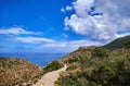 Typical Greek or Cretan landscape, hills and mountains, spring foliage, bush, olive tree, rocky road, path. Akrotiri Royalty Free Stock Photo