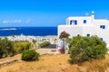 Typical Greek house on coast of Mykonos island with town and sea in background, Cyclades islands, Greece Royalty Free Stock Photo