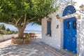 Typical greek house nwxt to the tree Royalty Free Stock Photo