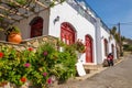 Typical Greek house with white walls and red wooden doors Royalty Free Stock Photo