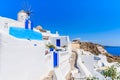 Typical Greek houses and windmill on street of Oia village, Santorini island, Greece Royalty Free Stock Photo