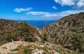 Typical Greek landscape, hill, spring foliage, bushes, olive trees. Clear blue sky, beautiful clouds. Akrotiri peninsula Royalty Free Stock Photo