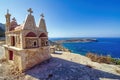 Typical Greek miniature roadside shrine. Small Greek Orthodox chapel at Crete with sea background