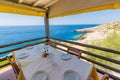 Traditional chairs with a table near the beautiful Greek sea at Zakynthos island in Greece Royalty Free Stock Photo