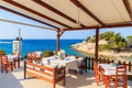 Typical Greek tavern in Kokkari bay, Samos island, Greece Royalty Free Stock Photo