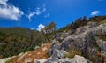 Typical Greek view, mountains, bushes, rocky slopes, wind-swept olive trees, blue sky, great clouds. Akrotiri peninsula Royalty Free Stock Photo