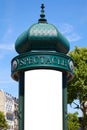 Typical green advertising column or Morris column with blank space in Paris in a sunny day in France