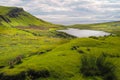 Typical green meadows and seaside of Isle of Skye, Scotland, on a sunny beautiful day of summer. Bright green and blue