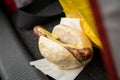 Typical grilled German Bratwurst sausage street food with bread roll bun and mustard in car on the go Royalty Free Stock Photo