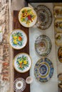 Typical handicraft product, hand painted plates hanging on the wall of a souvenir shop in Siena, Italy