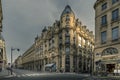 Typical Haussmann buildings and street near stock exchange market monument in paris Royalty Free Stock Photo