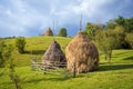 Typical hay bales and meadows of green grass and blue sky. Rural scene.