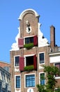 Typical house in Amsterdam with geraniums in window