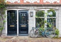 Typical house entrance with two doors and bicycle in Amsterdam Royalty Free Stock Photo