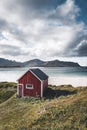 A typical house of the fishermen called rorbu on the beach frames the sea at Ramberg Lofoten Islands, Norway Europe Royalty Free Stock Photo