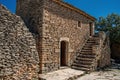 Typical house made of stone with staircase and sunny blue sky, in the Village of Bories, near Gordes. Royalty Free Stock Photo