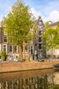 Typical Houses on the Amsterdam Canal and Car and Bicycles Royalty Free Stock Photo