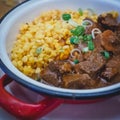 Typical Hungarian beef Goulash served in an enamel plate with onion and spetzles. Royalty Free Stock Photo