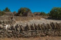 Typical hut made of stone with walled fence and sunny blue sky, in the Village of Bories, near Gordes. Royalty Free Stock Photo