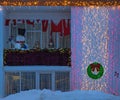 Typical Icelandic house fully decorated on the outside by Christmas lights and ornaments with a snowman on the balcony and Santa