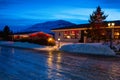 Typical Icelandic houses with Christmas decorations at the twilight near Akureyri, northern Iceland. Slippery road in the foregro