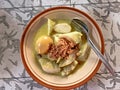 Typical Indonesian food called lontong opor, rice cake with yellow sauce and boiled eggs