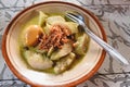 Typical Indonesian food called lontong opor, rice cake with yellow soup and boiled eggs