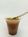 a typical Indonesian food called meatballs, served in a plastic cup with additional noodle filling and celery leaf topping topped Royalty Free Stock Photo