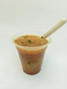 a typical Indonesian food called meatballs, served in a plastic cup with additional noodle filling and celery leaf topping topped Royalty Free Stock Photo