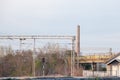 Typical industrial railway environment, with an electrified railroad line with train tracks and overhead power lines, railway sign Royalty Free Stock Photo