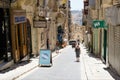 Valletta, Malta, August 2019. Sunlit shopping street in the old city.