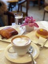 Typical italian breakfast with cappuccino and brioches