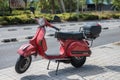 Typical Italian city motorcycle, the red Vespa P 200 E in the city Royalty Free Stock Photo