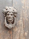 Typical Italian knocker on old wooden door Royalty Free Stock Photo