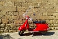 An old red retro Italian Vespa scooter