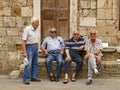 Group of Italian men sitting outside and discussing important issues