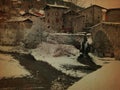 Typical Italian village in winter with stone houses, bridge and river