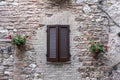 Typical Italian Window With Closed Wooden Shutters, Decorated With Fresh Flowers Royalty Free Stock Photo