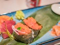 Typical Japanese dish of sushimi and onighiri on a leaf of bamboo Royalty Free Stock Photo