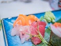 Typical Japanese dish of sushimi and onighiri on a leaf of bamboo Royalty Free Stock Photo