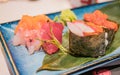 Typical Japanese dish of sushimi and onighiri on a leaf of bamboo Royalty Free Stock Photo