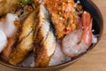 Typical Japanese fish donburi, shrimp tempura, raw shrimps, salmon fillets, grilled tuna, caviar, tuna tartare, sliced cucumbers,