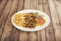A typical kebab dish with grilled minced lamb meat on a skewer, crinkled frenc