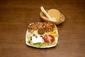 Typical kebab platter with falafel, onion, white rice, lamb meat and lettuce along with a portion of French fries on a white plate